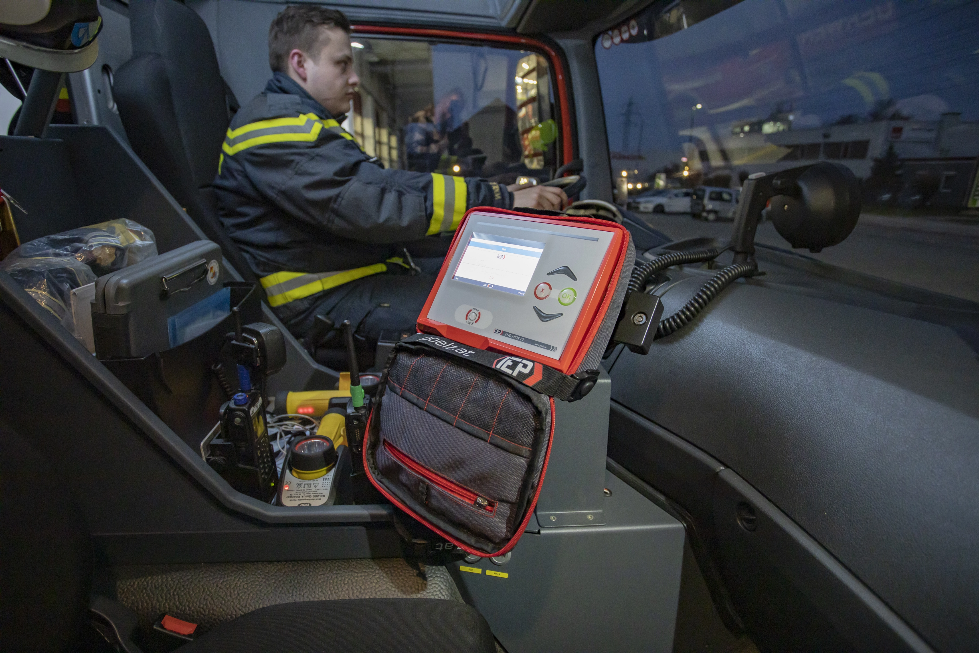 a man in a vehicle with a digital device